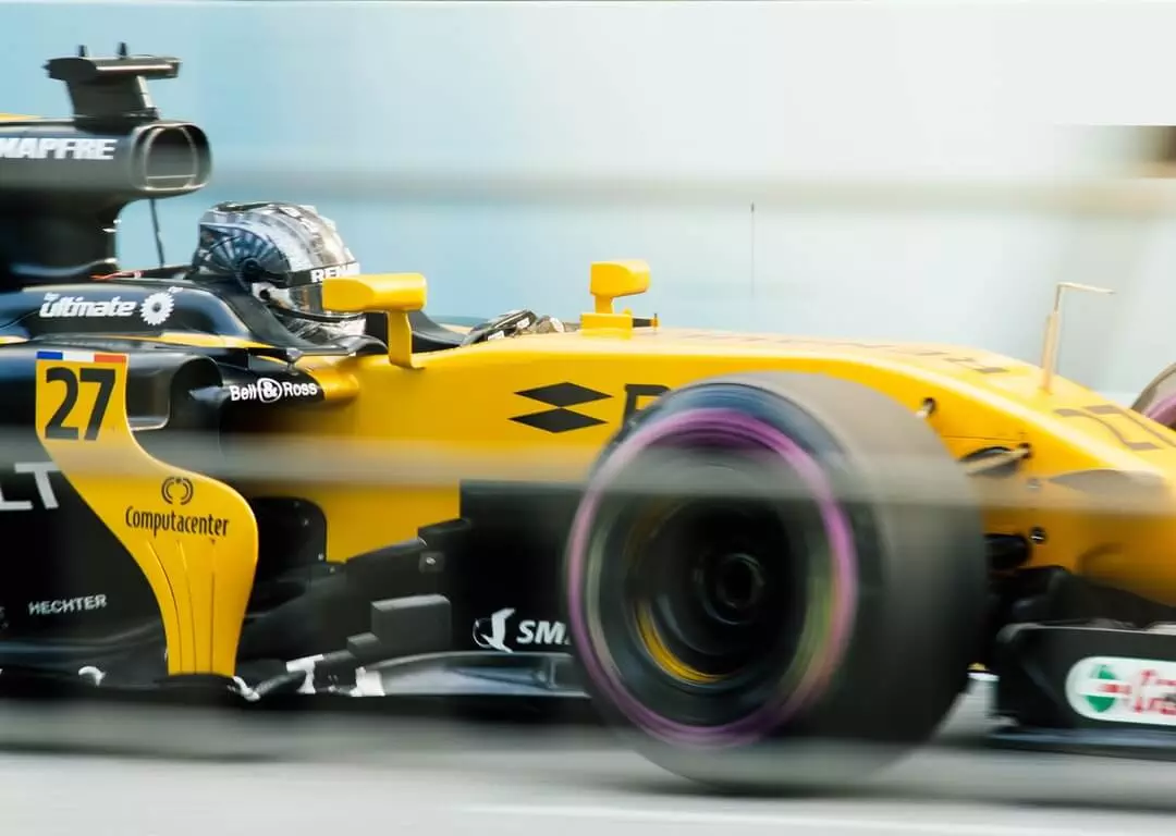 Yellow formula 1 racecar driving